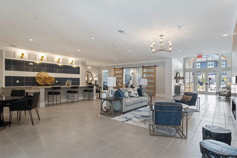 a living room with couches and chairs and a bar and a dining room